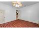 Spacious bedroom with wood-look floors and access to another room at 3548 Tuscany Reserve Blvd, New Smyrna Beach, FL 32168