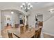 Bright dining room with hardwood floors and a chandelier at 3548 Tuscany Reserve Blvd, New Smyrna Beach, FL 32168