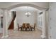 Formal dining room with elegant chandelier, wood table, and chair set, and large windows with shutter at 3548 Tuscany Reserve Blvd, New Smyrna Beach, FL 32168