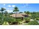 Luxury home with tile roof, palm trees, and landscaped grounds at 3548 Tuscany Reserve Blvd, New Smyrna Beach, FL 32168