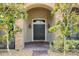 Elegant double front doors flanked by landscaping at 3548 Tuscany Reserve Blvd, New Smyrna Beach, FL 32168
