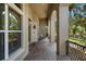 Side view of the covered porch with a rocking chair at 3548 Tuscany Reserve Blvd, New Smyrna Beach, FL 32168