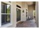 Covered front porch with rocking chair and brick flooring at 3548 Tuscany Reserve Blvd, New Smyrna Beach, FL 32168