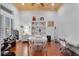 Bright home office with hardwood floors, built-in shelving, large window and a ceiling fan at 3548 Tuscany Reserve Blvd, New Smyrna Beach, FL 32168