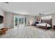 Large main bedroom with hardwood floors and sliding doors to the pool area at 3548 Tuscany Reserve Blvd, New Smyrna Beach, FL 32168