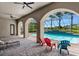 Covered patio overlooking a refreshing pool and lush landscape at 3548 Tuscany Reserve Blvd, New Smyrna Beach, FL 32168