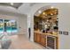 Wet bar with wine storage, beverage cooler, and granite countertop at 3548 Tuscany Reserve Blvd, New Smyrna Beach, FL 32168