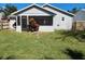 Large backyard with grassy area and screened patio at 3566 Red Pontiac Dr, Port Orange, FL 32129