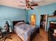 Bedroom with a double bed, wood floors, and a walk-in closet at 3566 Red Pontiac Dr, Port Orange, FL 32129