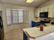 Bright kitchen with white cabinets and a corner window at 3566 Red Pontiac Dr, Port Orange, FL 32129