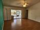 Spacious living room with wood floors and access to a screened patio at 3566 Red Pontiac Dr, Port Orange, FL 32129