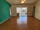 Bright living room with wood floors and sliding doors to a patio at 3566 Red Pontiac Dr, Port Orange, FL 32129