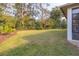 Landscaped backyard with grassy area and privacy hedge at 3605 Galway Ln, Ormond Beach, FL 32174