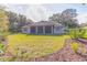 Large backyard with grassy area and mature trees at 3605 Galway Ln, Ormond Beach, FL 32174