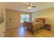 Bright bedroom with wood flooring, large window, and a comfortable sleigh bed at 3605 Galway Ln, Ormond Beach, FL 32174