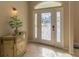 Elegant entryway with decorative cabinet and stained-glass door at 3605 Galway Ln, Ormond Beach, FL 32174