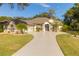 Single-story house with a circular driveway and landscaped lawn at 3605 Galway Ln, Ormond Beach, FL 32174