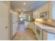 Kitchen boasts white cabinets, tile floor, and breakfast nook at 3605 Galway Ln, Ormond Beach, FL 32174