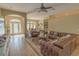 Spacious living room with a large sectional sofa and hardwood floors at 3605 Galway Ln, Ormond Beach, FL 32174