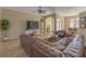 Living room with hardwood floors, sectional sofa, and large TV at 3605 Galway Ln, Ormond Beach, FL 32174