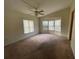 Spacious bedroom with neutral carpeting and large windows at 3669 General Marshall Rd, Daytona Beach, FL 32124