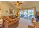 Living area with brown sectional sofa and sliding doors to pool area at 405 Oak River Dr, Port Orange, FL 32127