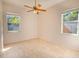 Bright bedroom with neutral walls, tile flooring, and natural light from two windows at 419 Still Forest Ter, Sanford, FL 32771