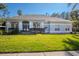Charming single-story home featuring a well-manicured lawn, blue front door, and lush landscaping at 419 Still Forest Ter, Sanford, FL 32771