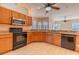 Bright eat-in kitchen featuring wood cabinetry, granite counters, and modern appliances at 419 Still Forest Ter, Sanford, FL 32771