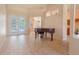 Open-concept living area boasts neutral tile flooring and offers seamless access to the screened-in pool area at 419 Still Forest Ter, Sanford, FL 32771