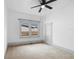 Simple bedroom with carpet, ceiling fan, and window at 448 E Church St, Deland, FL 32724
