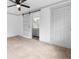 Bedroom with sliding barn door revealing an ensuite bathroom at 448 E Church St, Deland, FL 32724