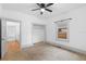 Well-lit bedroom with carpet, ceiling fan and closet at 448 E Church St, Deland, FL 32724