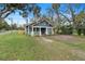 Charming blue bungalow with front porch and lush landscaping at 448 E Church St, Deland, FL 32724