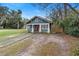 Charming bungalow with blue siding, red door, and walkway at 448 E Church St, Deland, FL 32724