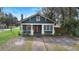 Cozy craftsman-style home with bright red door and inviting facade at 448 E Church St, Deland, FL 32724