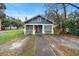 Classic blue house with a red door, situated on a sunny corner lot at 448 E Church St, Deland, FL 32724