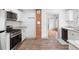 Modern kitchen with white shaker cabinets, granite counters, and stainless steel appliances at 448 E Church St, Deland, FL 32724