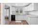 Modern kitchen with white shaker cabinets, granite counters, and stainless steel appliances at 448 E Church St, Deland, FL 32724