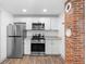 Modern kitchen with white shaker cabinets, granite counters, and stainless steel appliances at 448 E Church St, Deland, FL 32724