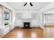 Living room with hardwood floors, fireplace, and ceiling fan at 448 E Church St, Deland, FL 32724