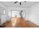 Open living room with spiral staircase and hardwood floors at 448 E Church St, Deland, FL 32724