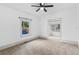 Bright living room with ceiling fan, carpet, and view of sun porch at 448 E Church St, Deland, FL 32724