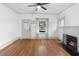 Bright living room with hardwood floors, fireplace, and large window at 448 E Church St, Deland, FL 32724