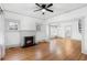 Living room with hardwood floors, fireplace, and ceiling fan at 448 E Church St, Deland, FL 32724