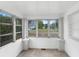 Sun-filled sun porch with ample windows and view of the street at 448 E Church St, Deland, FL 32724