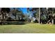 Large grassy backyard surrounded by trees at 487 Dawnview Sq, Port Orange, FL 32127