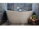Relaxing bathroom with a freestanding bathtub and marble tile at 487 Dawnview Sq, Port Orange, FL 32127