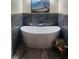 Relaxing bathroom featuring a freestanding bathtub and marble tile at 487 Dawnview Sq, Port Orange, FL 32127