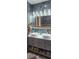 Stylish bathroom featuring double sinks, basket storage, and decorative tile at 487 Dawnview Sq, Port Orange, FL 32127
